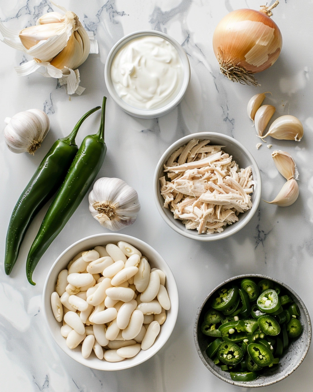 ingredients for sour cream white chicken chili on marble surface