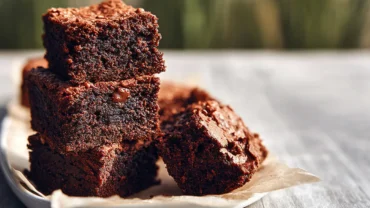 Brownies with Almond Flour stacked on a wooden board