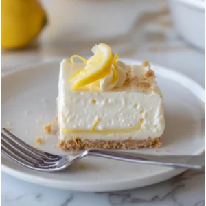 Bowl of lemon cheesecake filling with lemon zest on top