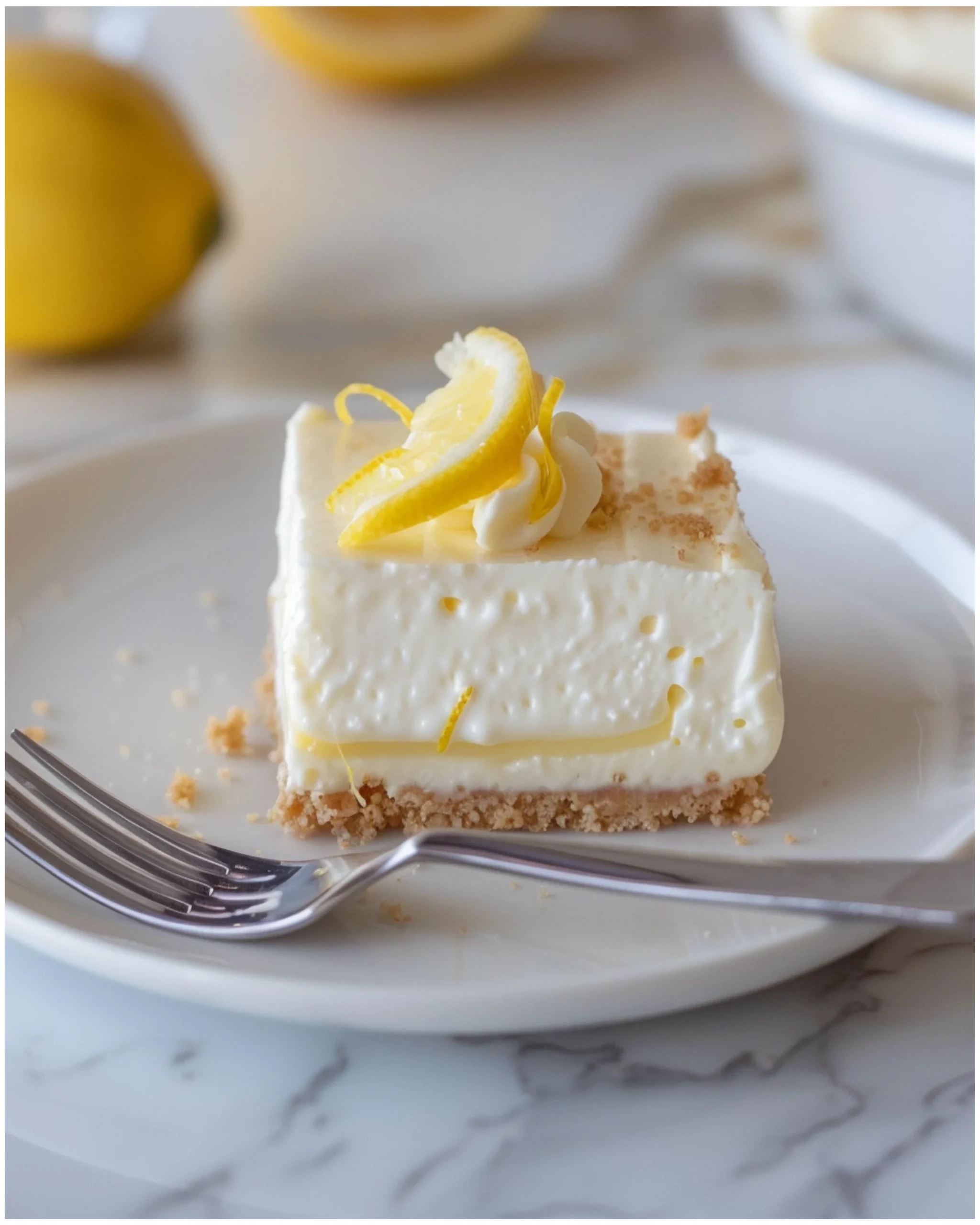 Bowl of lemon cheesecake filling with lemon zest on top