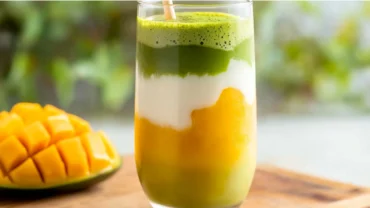 iced mango matcha latte in layered glass