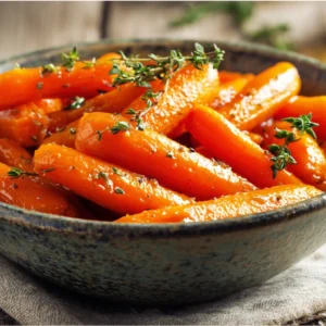maple glazed carrots with thyme in ceramic bowl