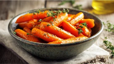 maple glazed carrots with thyme in ceramic bowl