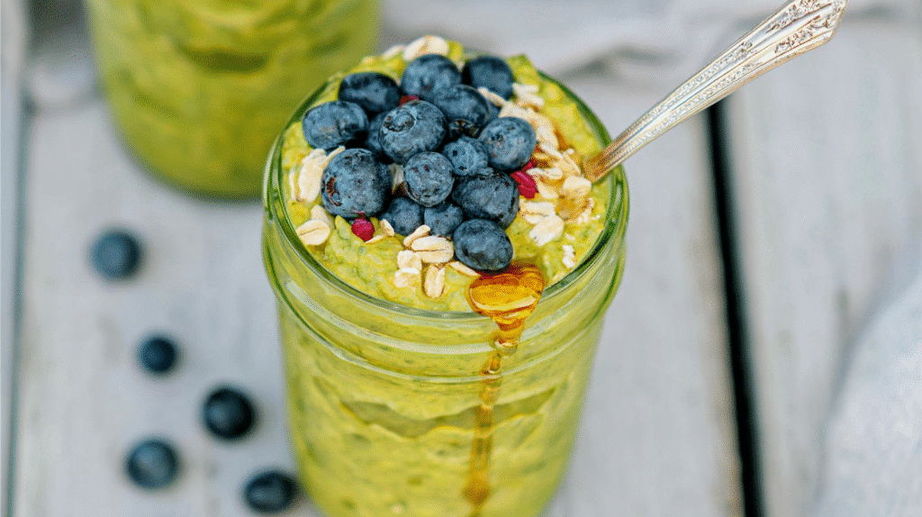 matcha overnight oats with berries in a glass jar
