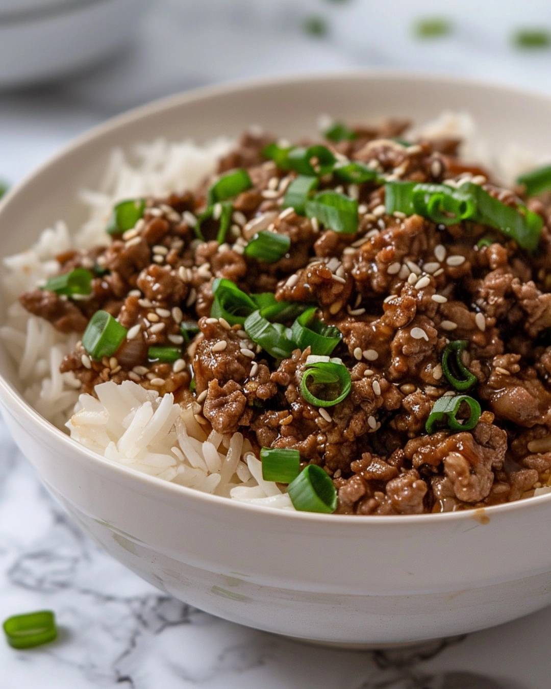 Serving Ground Beef Bowl with rice and sesame seeds