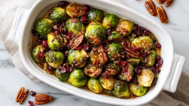 Top-down view of maple roasted Brussels sprouts with cranberries and pecans.