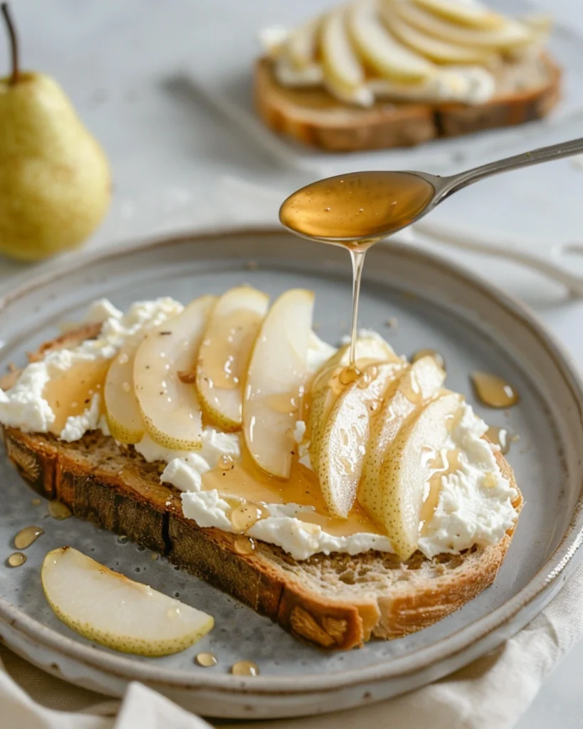 Assembling pear ricotta toast with honey drizzle