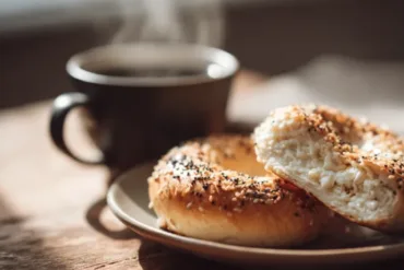 Freshly baked cottage cheese bagel sliced on board