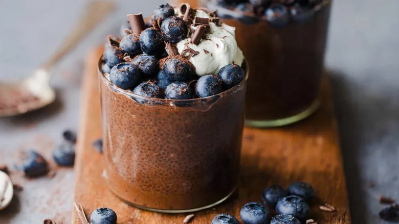 chocolate yogurt chia pudding in a jar with toppings
