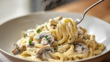 Creamy mushroom pasta close-up on modern wood table