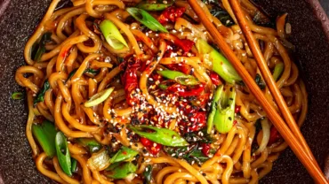 Spicy noodles recipe in rustic bowl