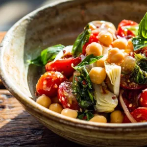 Tuscan tomato salad with chickpeas and basil in a bowl