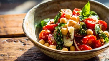 Tuscan tomato salad with chickpeas and basil in a bowl