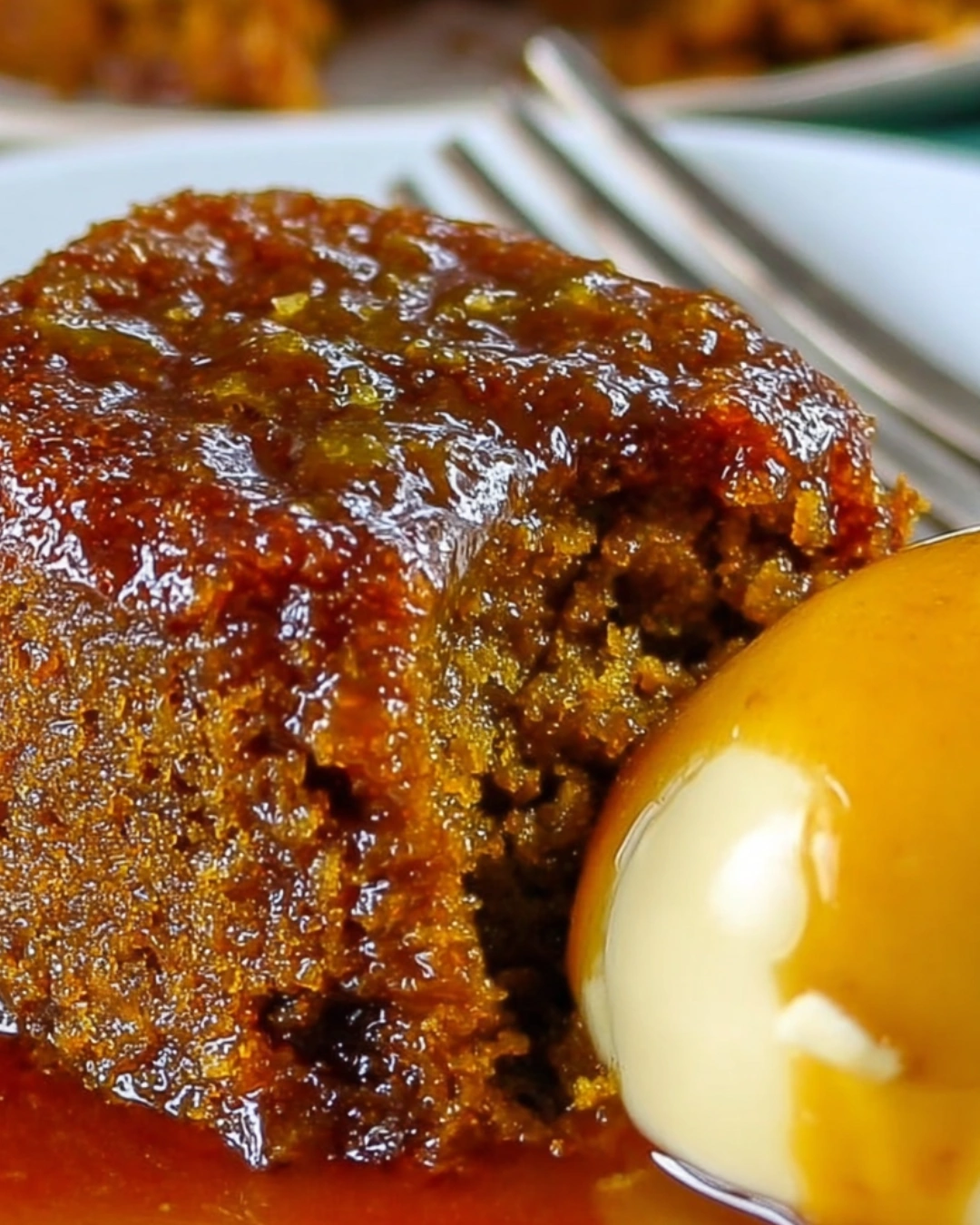 Sticky Toffee Pudding served with melting vanilla ice cream and caramel drizzle