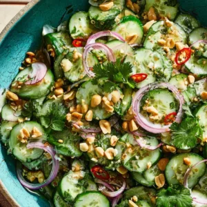 Thai cucumber salad with peanuts, chili, and red onion