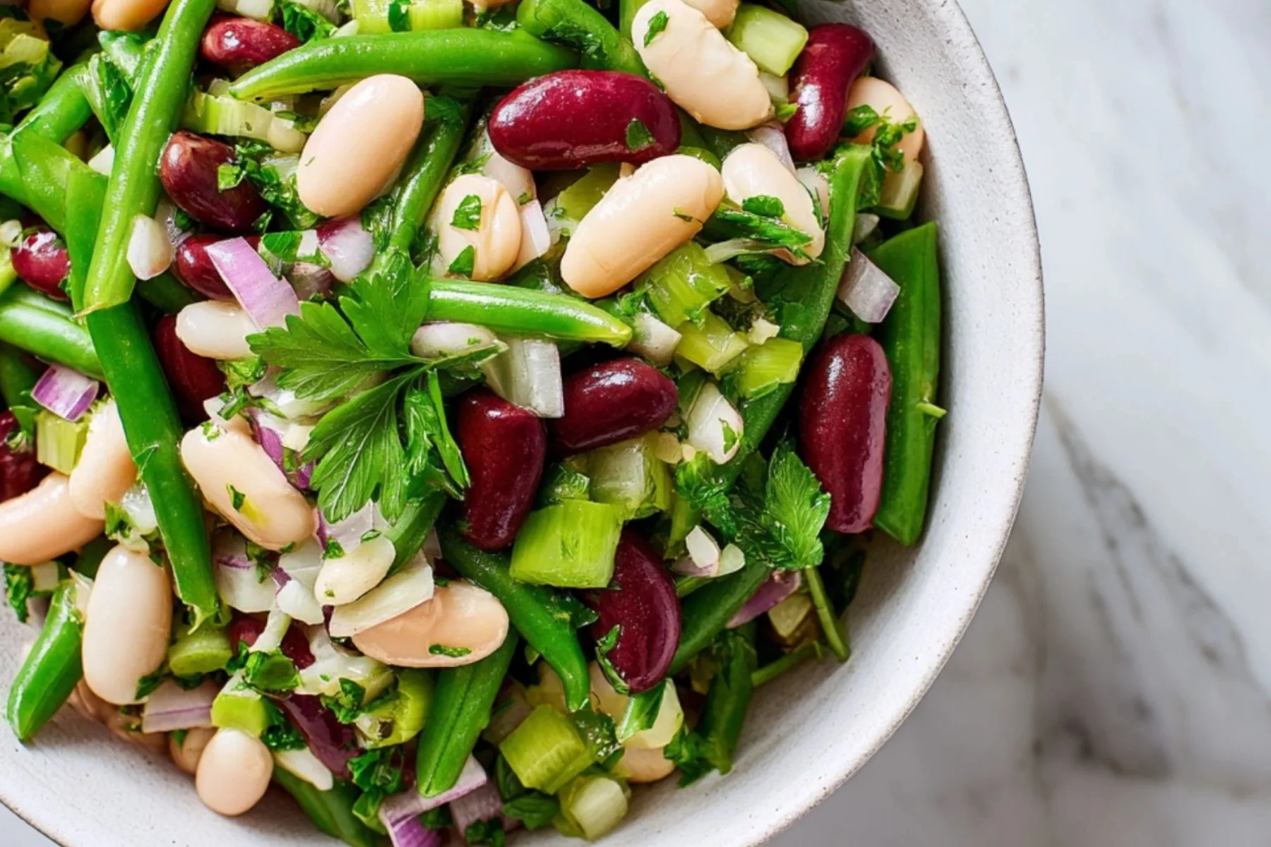 Three Bean Salad with green, kidney, and white beans in tangy vinaigrette