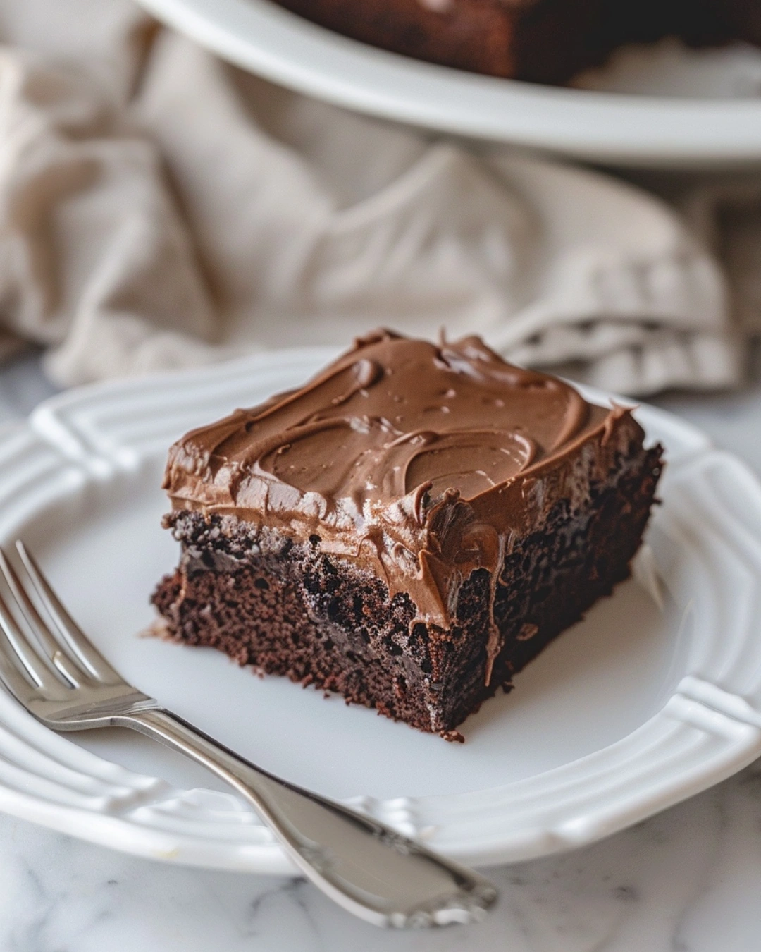 Slice of moist Chocolate Sheet Cake served on plate