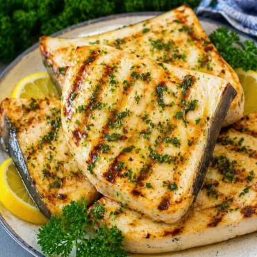 Grilled swordfish steak served with lemon herb sauce