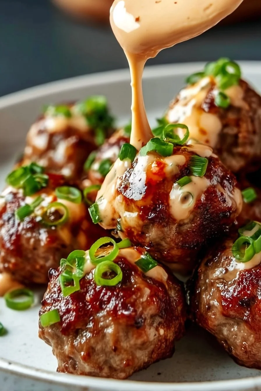 Korean BBQ meatballs served with spicy mayo dip on a plate