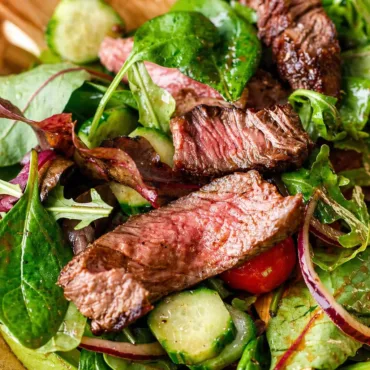 Delicious Easy Juicy Steak Salad topped with creamy balsamic vinaigrette and fresh ingredients.