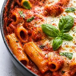 Delicious Easy One-Pan Lasagna served in a skillet with layers of cheese and meat sauce.