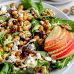 Delicious Spinach Apple Chickpea Salad with nuts and vibrant ingredients.