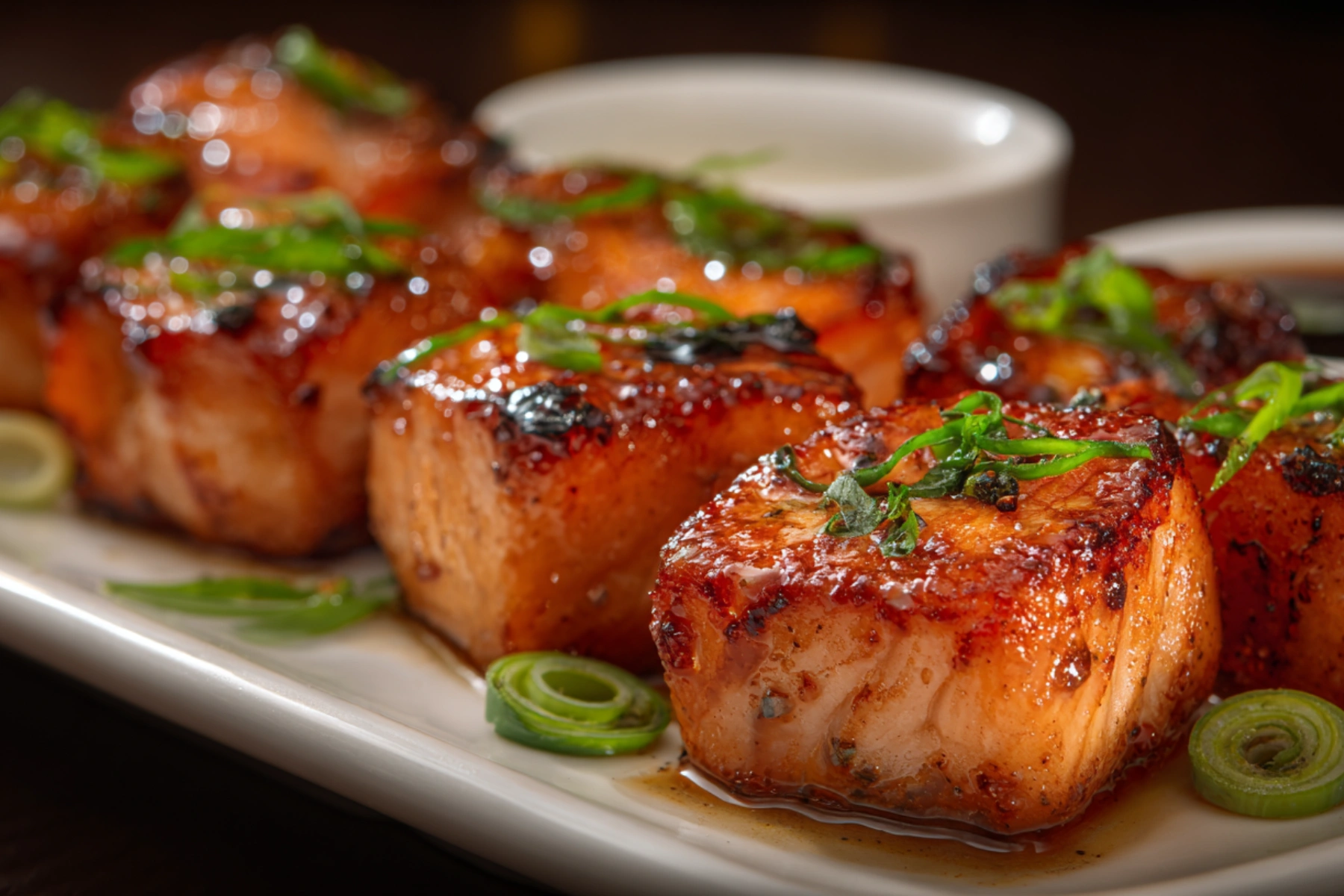 Crispy Bang Bang Salmon Bites with sweet and spicy sauce on a plate.