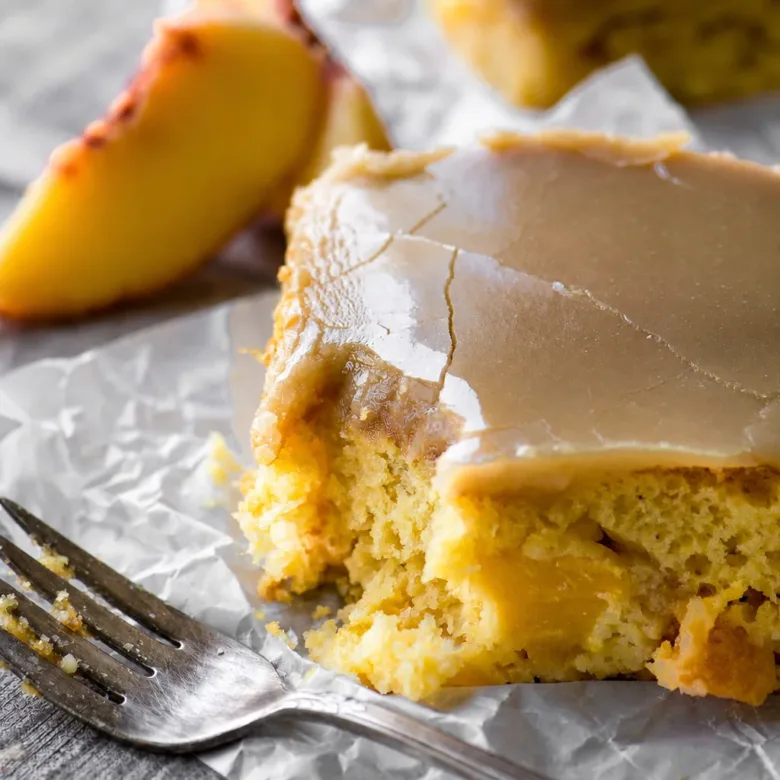 Vegan Peach Sheet Cake topped with irresistible brown sugar frosting and fresh peaches