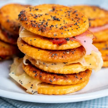 Ritz Cracker Party Sandwiches with ham and Swiss cheese topped with buttery glaze.