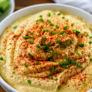 Creamy Deviled Egg Dip served with crackers and veggies, a delicious appetizer.