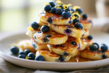Lemon Blueberry Cottage Cheese Pancake Bites served with fresh blueberries