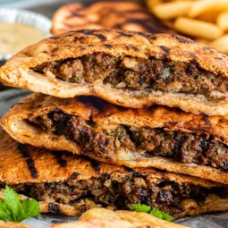 Ground Beef Pita Pockets filled with spiced meat and fresh ingredients served on a plate.