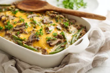 Hamburger Green Bean Casserole with Mushrooms baked with melted cheddar cheese