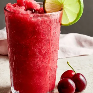 4-Ingredient Low-Carb Cherry Lime Slushie served on a summer patio