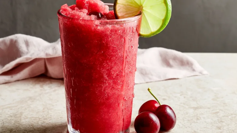 4-Ingredient Low-Carb Cherry Lime Slushie served on a summer patio