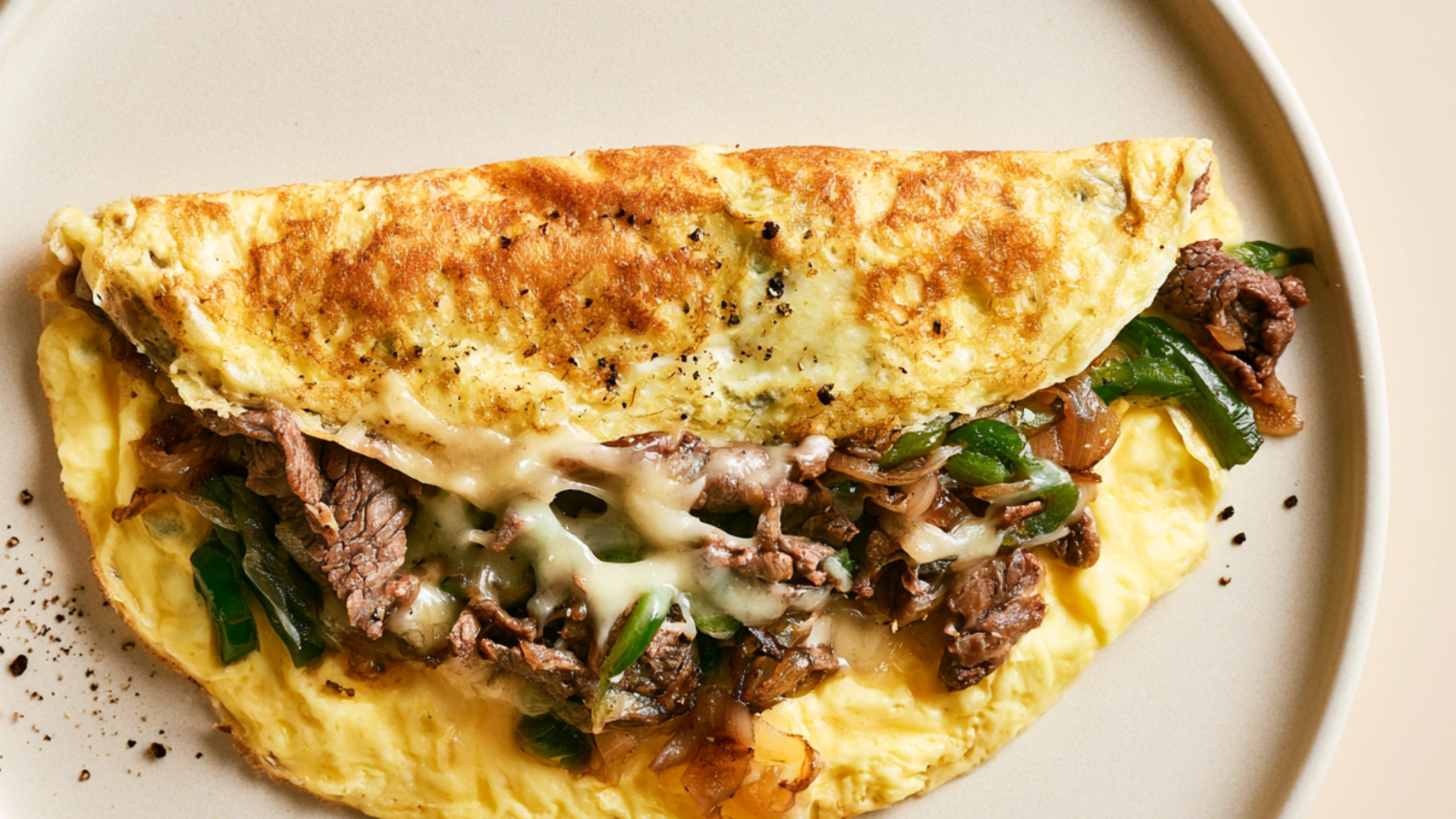 Philly Cheesesteak Omelette with steak, peppers, onions and melted provolone