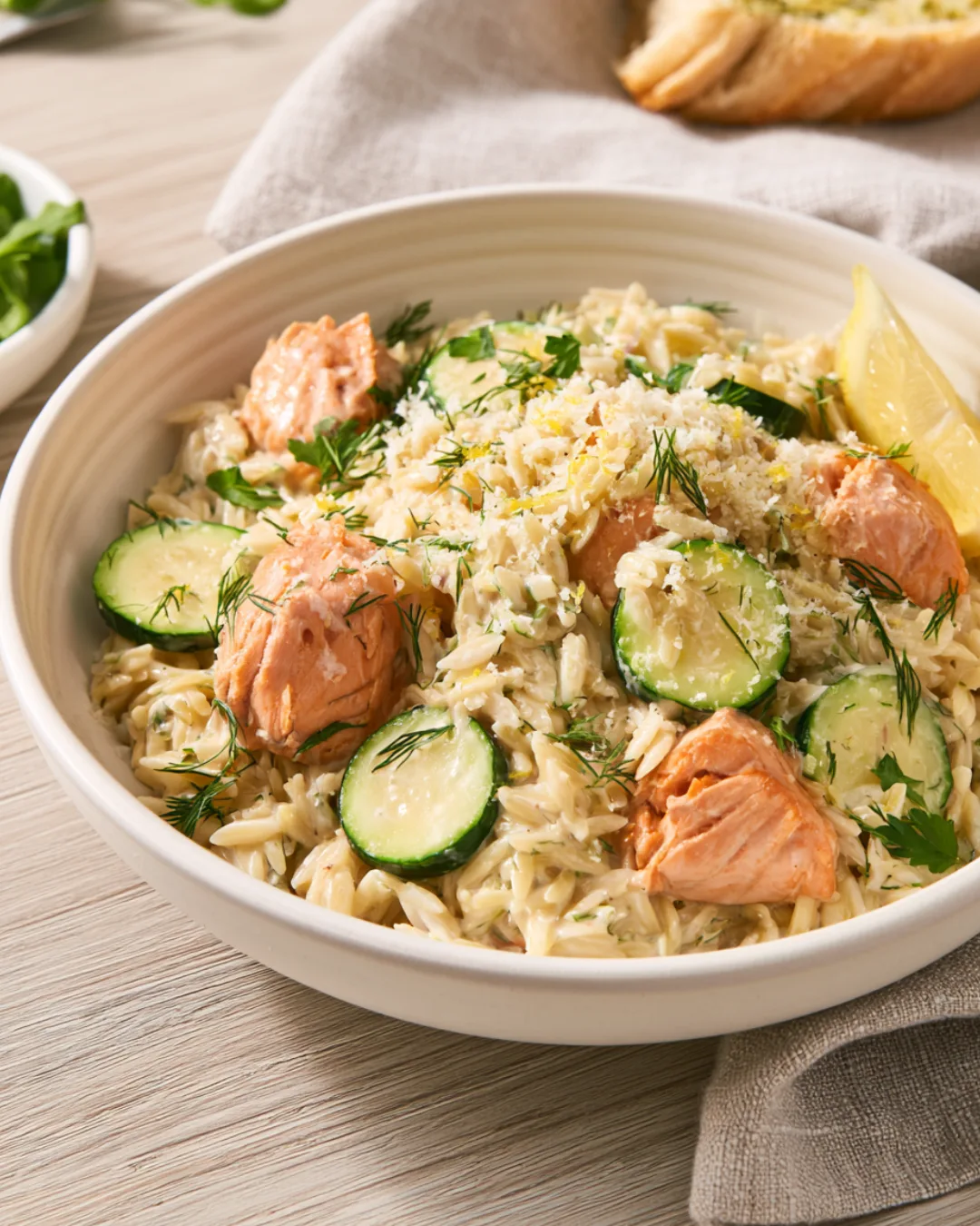 Salmon Zucchini Orzo Pasta served with green salad and garlic bread