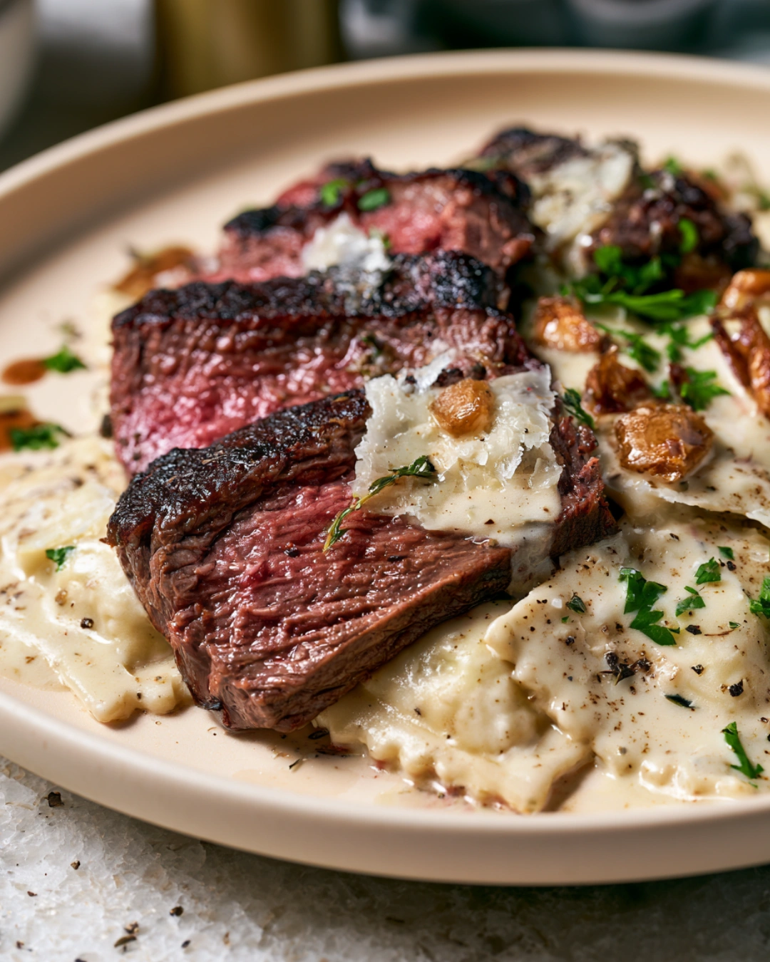 Steak and Ravioli with Creamy Garlic Herb Sauce served for dinner